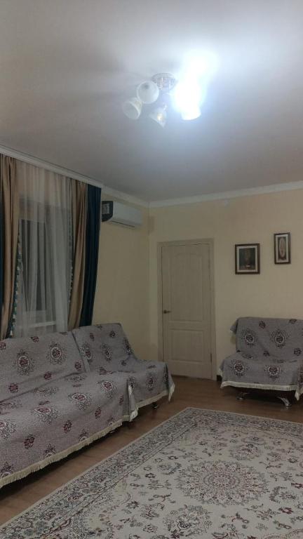 a bedroom with two beds and a ceiling at Гостевой дом Самурук in Atyrau