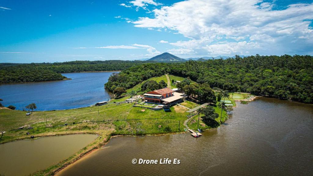 an aerial view of a house on an island in a river at Pousada Peninsula Santa Rita in Guarapari