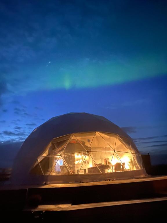 a domed building with lights in it at night at Hvítuborgir in Minni-Borg