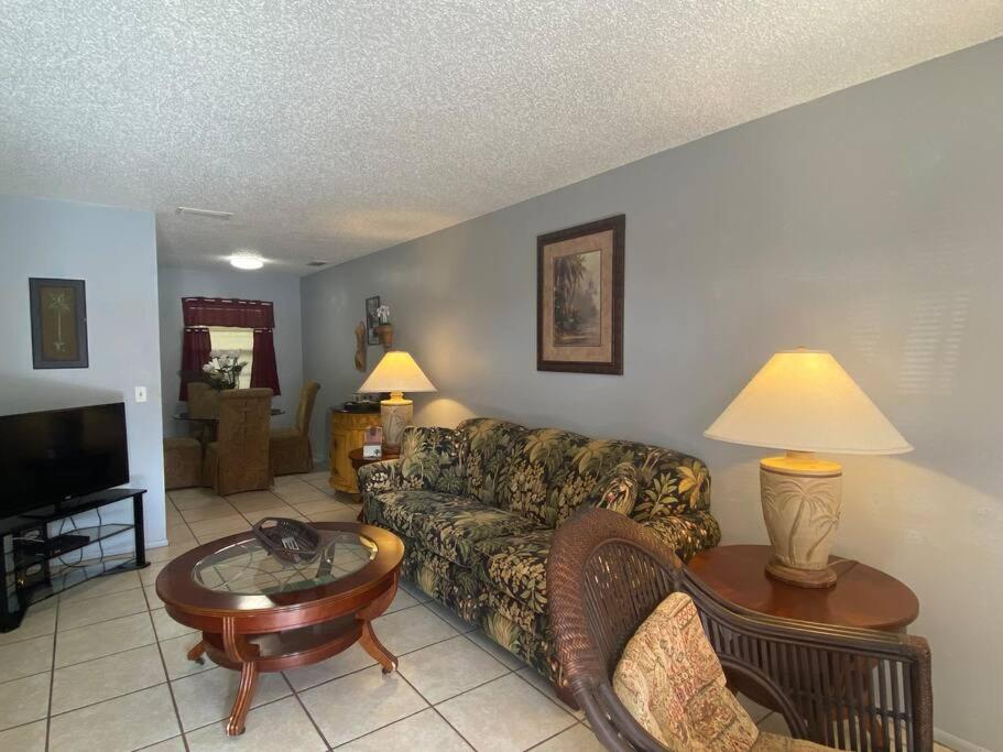 a living room with a couch and a table at Professor Rousseau's Palm Paradise in Crystal River