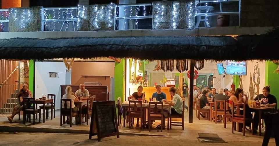 a group of people sitting at tables in a restaurant at El Ultimo Maya in Akumal