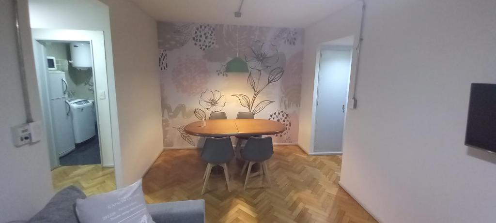 a dining room with a table and chairs in a room at Departamento en Recoleta in Buenos Aires