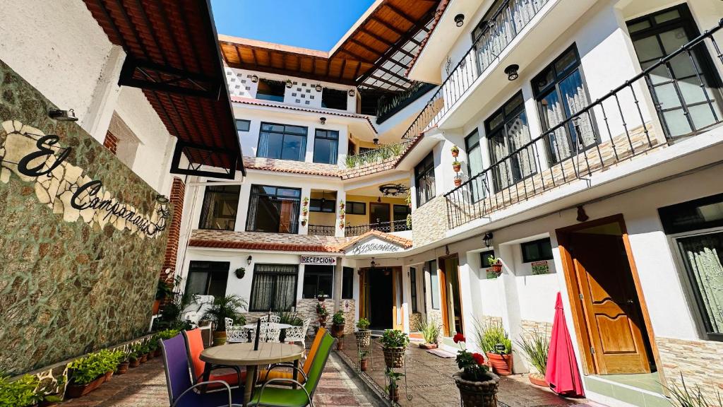 a courtyard of a building with a table and chairs at Posada El Campanario in Valle de Bravo