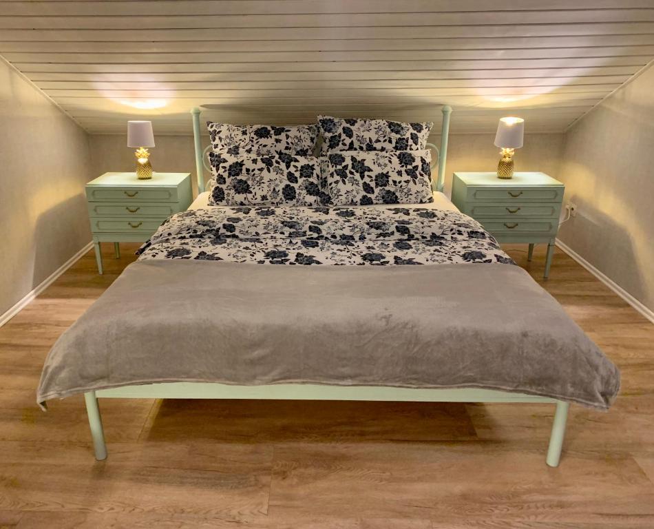 a bedroom with a bed with two night stands at Ihr Zuhause im Herzen von Baden in Dielheim