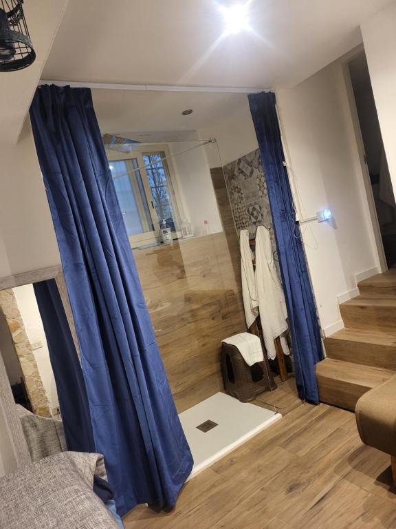 salon z niebieskimi zasłonami i schodami w obiekcie Il Rifugio w mieście Palermo