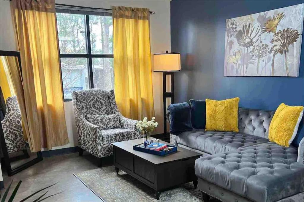 a living room with a couch and a chair at Luxury Midtown Flats near Downtown Memphis & FedEx Forum in Memphis