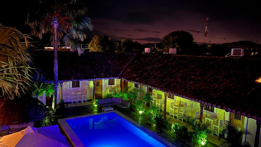 a house with a swimming pool at night at Encuentros in Granada