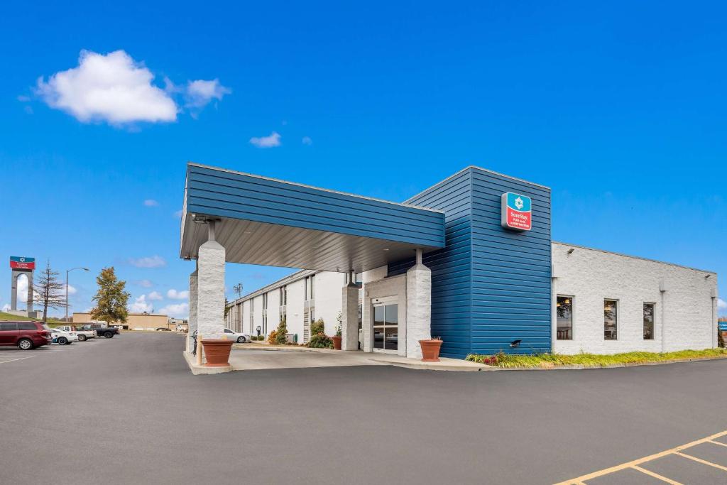 a gas station with a blue and white building at SureStay Plus Hotel by Best Western Jasper in Jasper