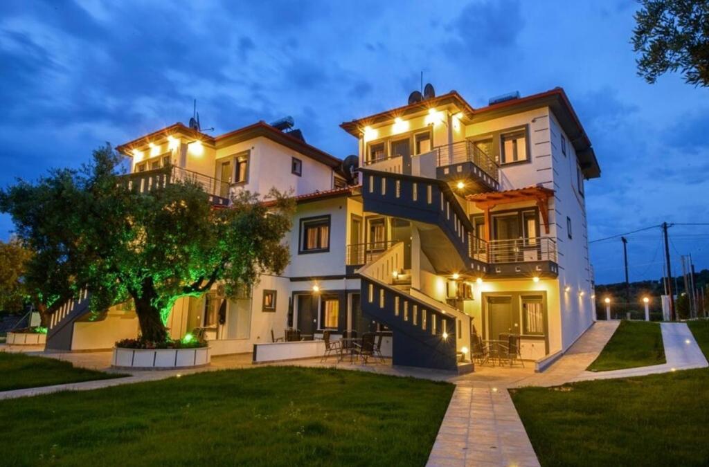 a large white house with lights on it at Bella Mare Villa Sithonia in Akti Salonikiou