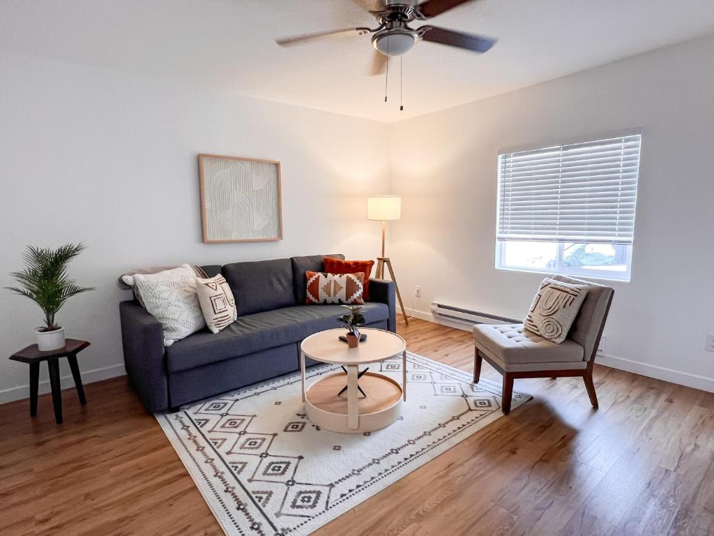 a living room with a couch and a table at Beautiful Work Stay Retreat in Pueblo Near Downtown in Pueblo