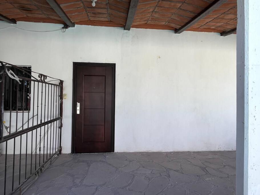 a room with a door and a white wall at Flores Condominios Depa Lili in Álamos