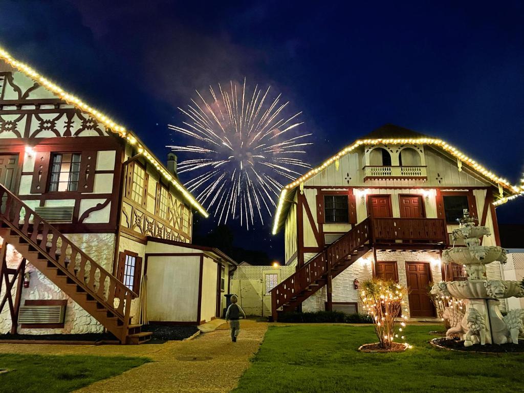 a person standing in front of a house with fireworks at Alpine Village Inn in Helen