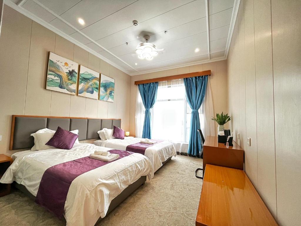 Postel nebo postele na pokoji v ubytování Siargao Seasky Resort