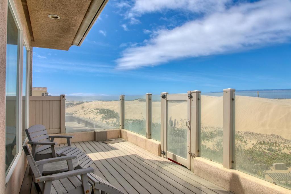 a balcony with a chair and a view of the desert at 1460 Strand Way in Oceano