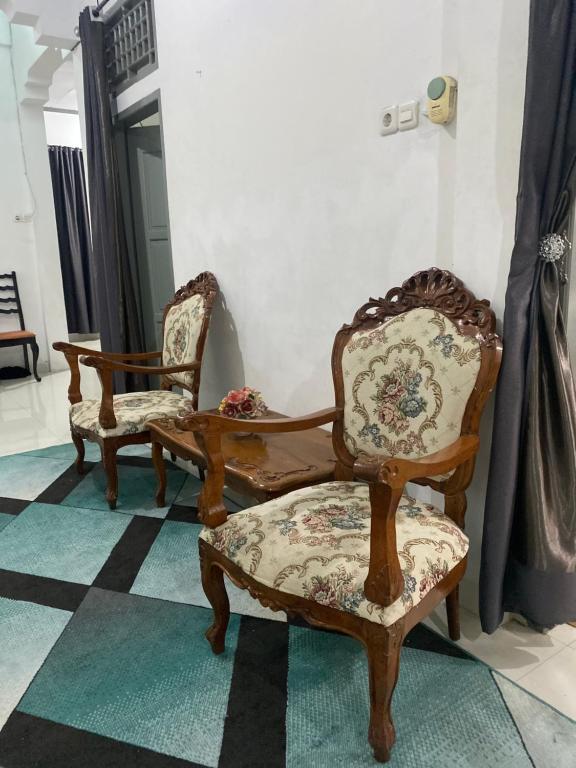 a couple of chairs sitting on top of a floor at Lorent Hostel Near Padang Beach in Padang