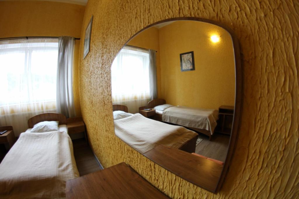Pokój szpitalny z 2 łóżkami i lustrem w obiekcie Gościniec Głuchołazy Zdrój w mieście Głuchołazy