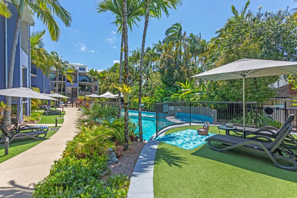 a pool with chairs and umbrellas at a resort at Verano Resort Noosa in Noosaville