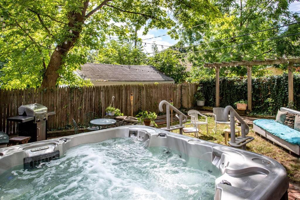 a hot tub in a backyard with a fence at ~Hot Tub~ in a Quiet Home near UofR/Dwnt/Aiprt/RIT in Rochester