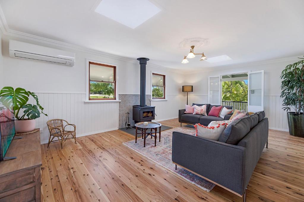 a living room with a couch and a stove at Maleny Town Stay in Maleny