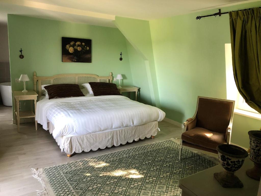 um quarto verde com uma cama e uma cadeira em Cottage Jardin Duplex of 70 m² for 2 people – 1 bedroom – 2 bathrooms – em Azay-le-Rideau