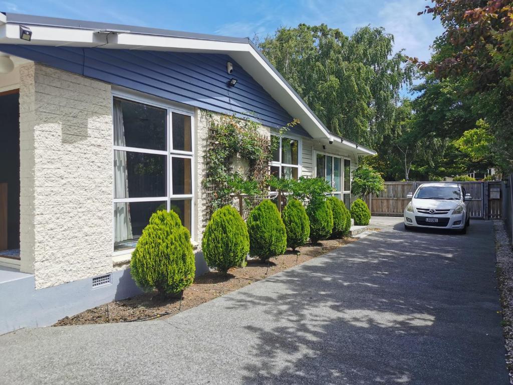 a house with a car parked in the driveway at Airport accommodation in Christchurch