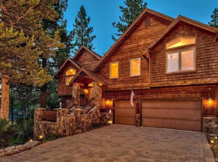 a wooden house with a garage in front of it at Tahoe Alpine Lodge in South Lake Tahoe