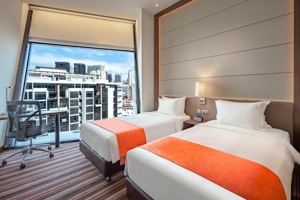 Giường trong phòng chung tại Holiday Inn Express Singapore Clarke Quay by IHG