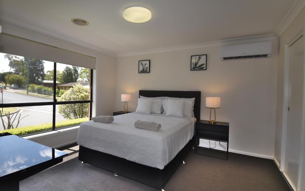 a bedroom with a bed and a large window at Holiday Home in Koonawarra in Dapto
