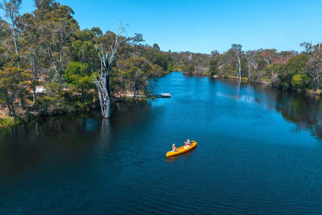 a group of people in a boat on a river at Donnelly Lakes in Pemberton