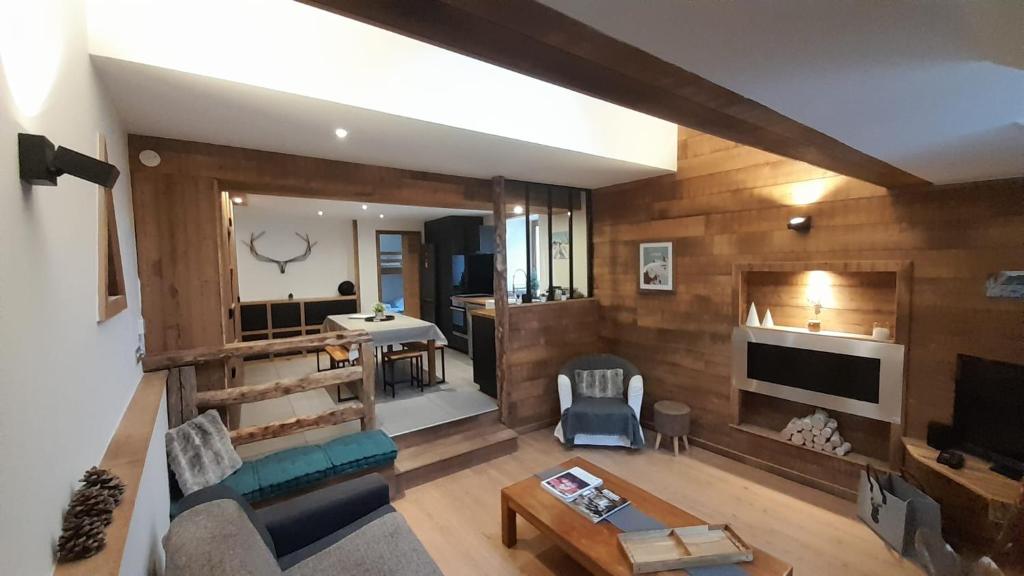 y vistas a una sala de estar con paredes de madera. en Le repaire du vieux cerf en Le Monêtier-les-Bains