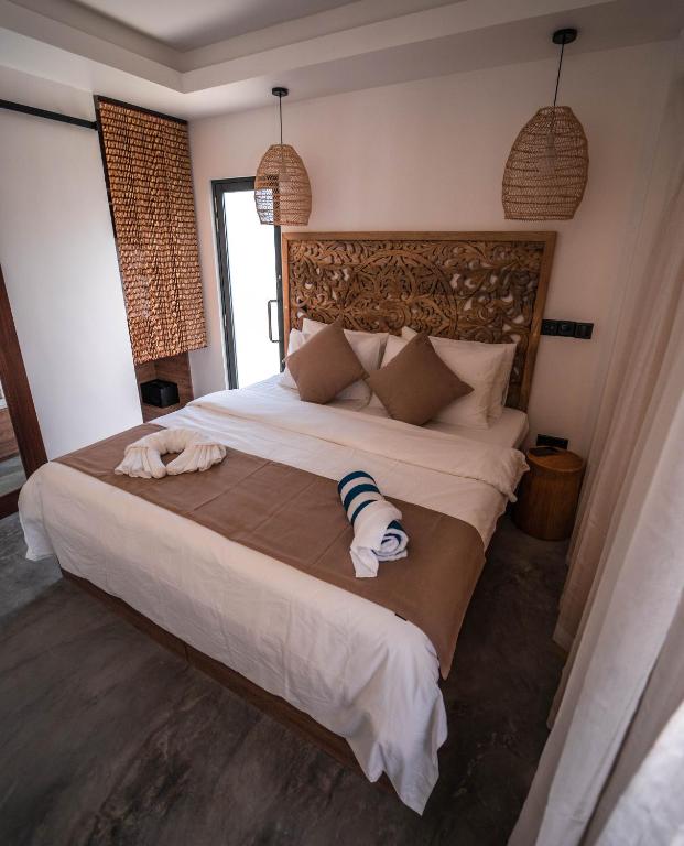 Postel nebo postele na pokoji v ubytování kunaa beach Inn