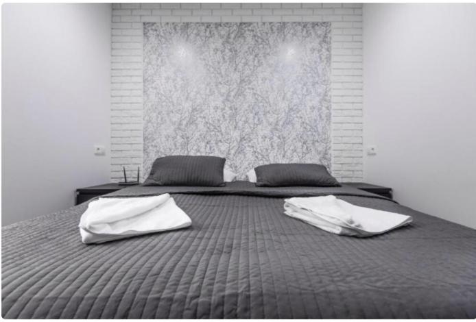 Posteľ alebo postele v izbe v ubytovaní White Apartment