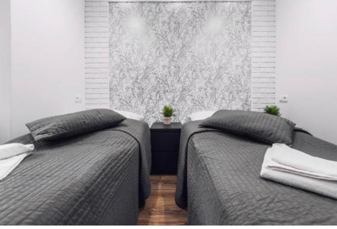 Posteľ alebo postele v izbe v ubytovaní White Apartment