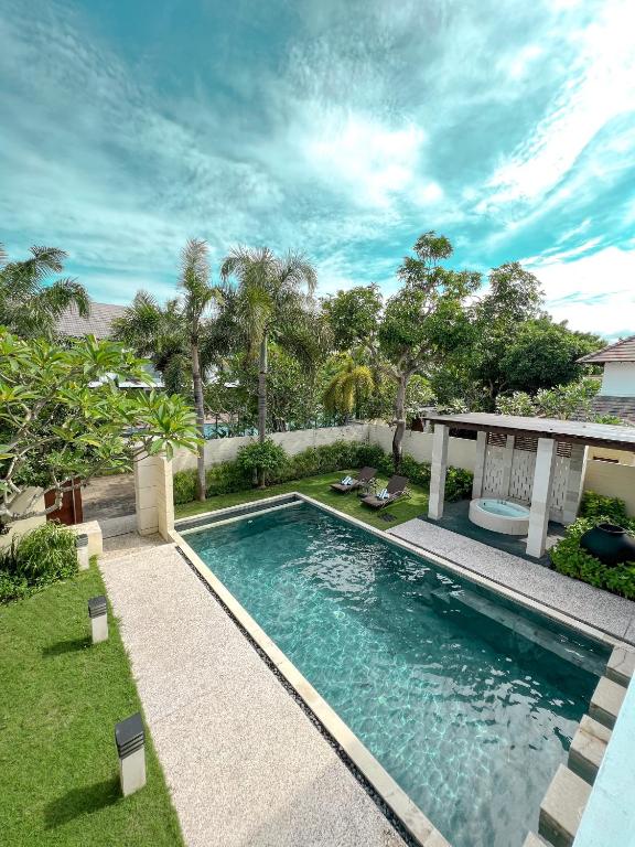 a swimming pool in the backyard of a house at The Wangsa Hotel and Villas Benoa in Nusa Dua