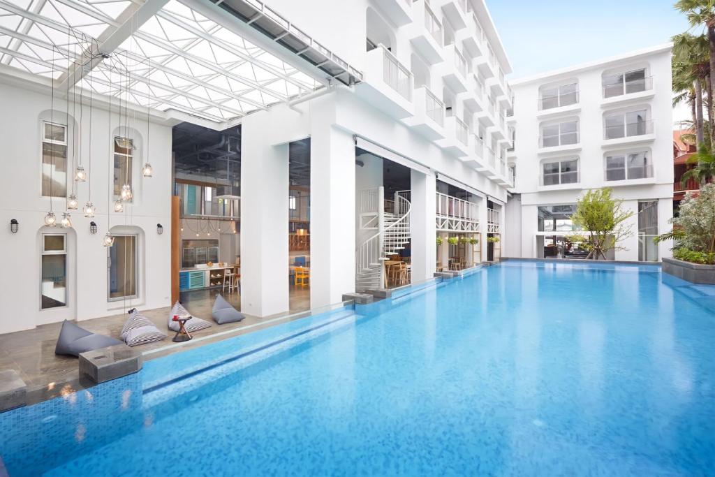 a swimming pool in the middle of a building at Lub d Phuket Patong in Patong Beach