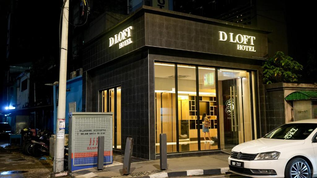 a white car parked in front of a store at D Loft Hotel in Kuala Lumpur
