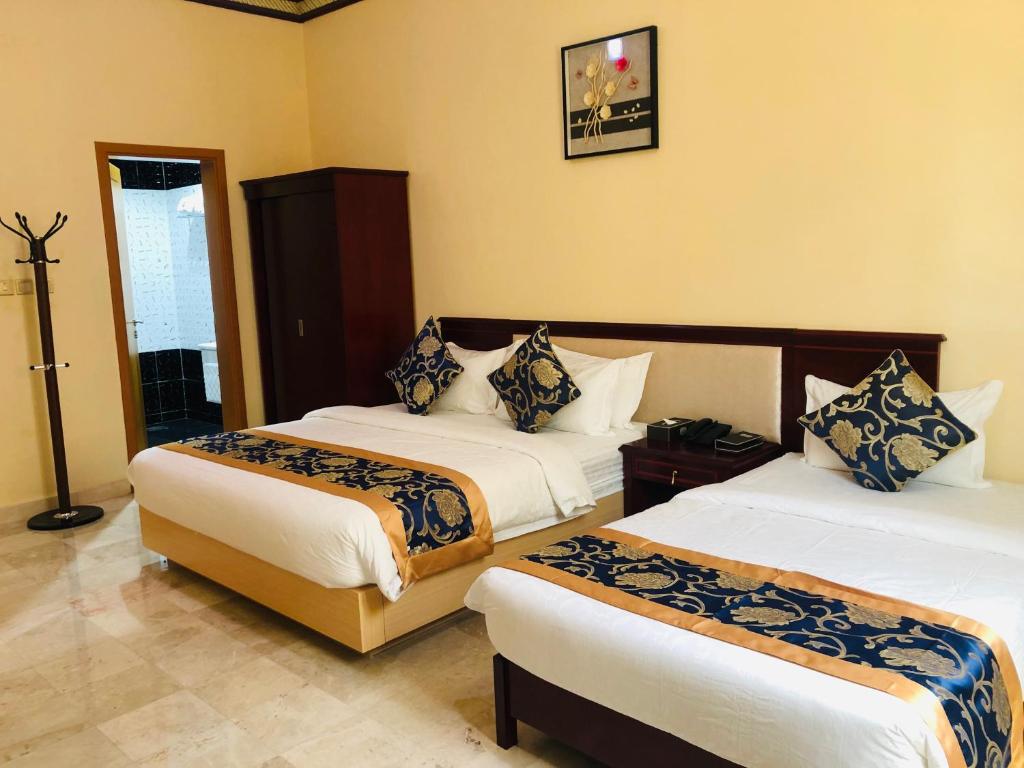 Postel nebo postele na pokoji v ubytování Farah Hotel Apartment