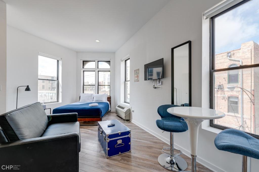 a living room with a couch and a table at 747 Lofts by RedAwning - River West, Second Floor Chicago in Chicago