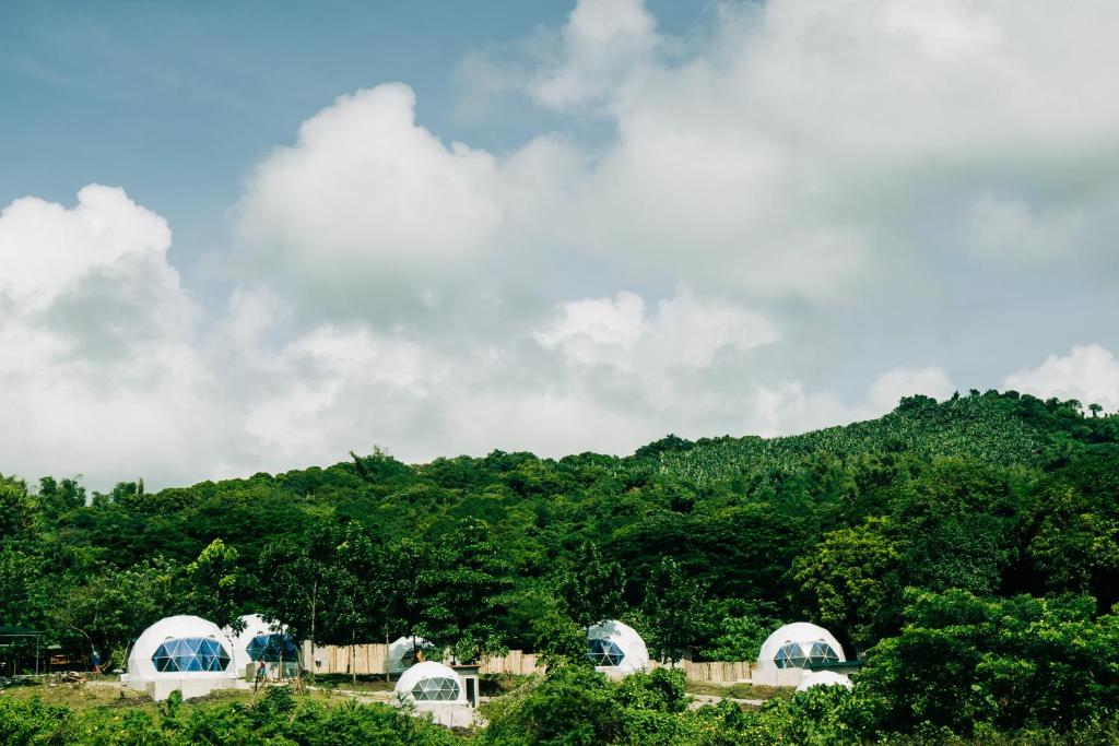 a group of domes in front of a mountain at lakescape hotsprings dome glamping in Lubo