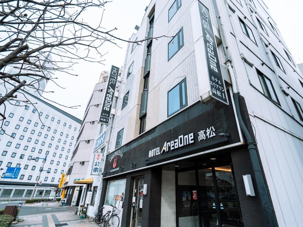 a building with a sign on the front of it at Hotel AreaOne Takamatsu in Takamatsu