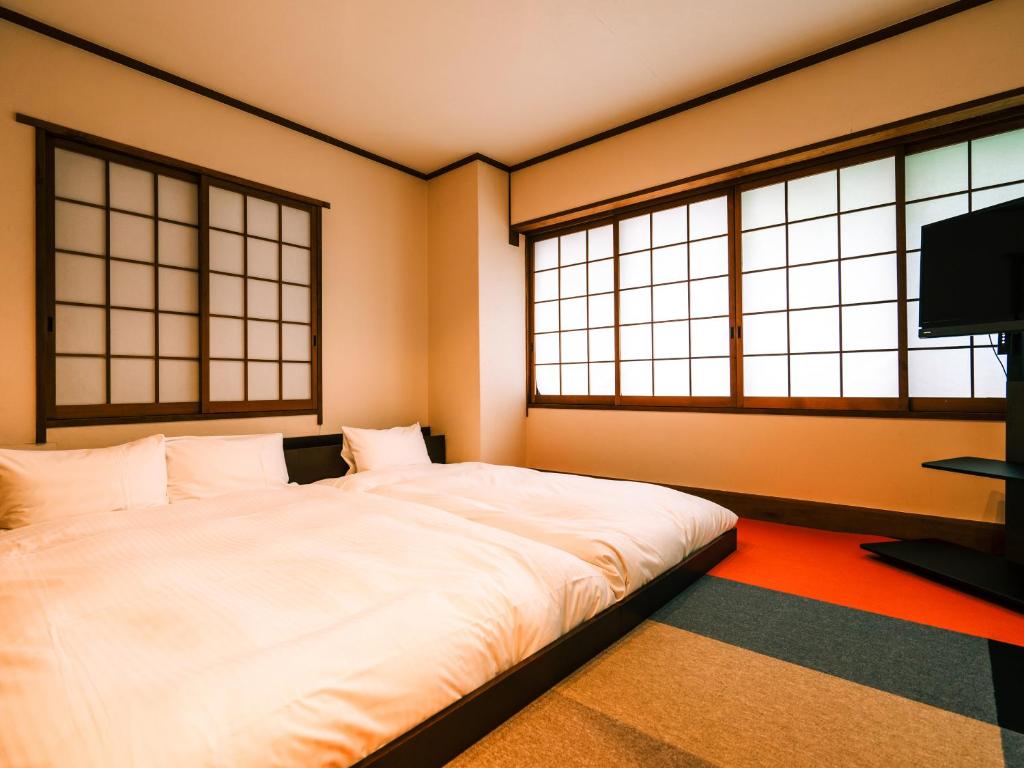 Postel nebo postele na pokoji v ubytování Hotel AreaOne Takamatsu