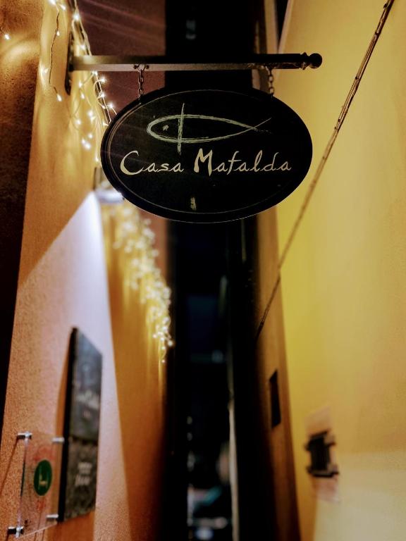 a sign that reads casa matale on the side of a building at Casa Mafalda in Chioggia