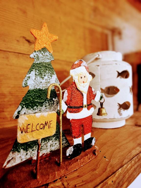 a figurine of a santa clause and a christmas tree at Casa Mafalda in Chioggia
