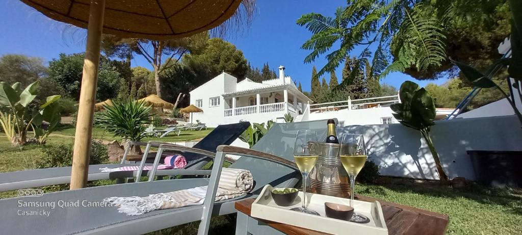 a table with a bottle of wine and a glass of wine at casanicky in Mijas