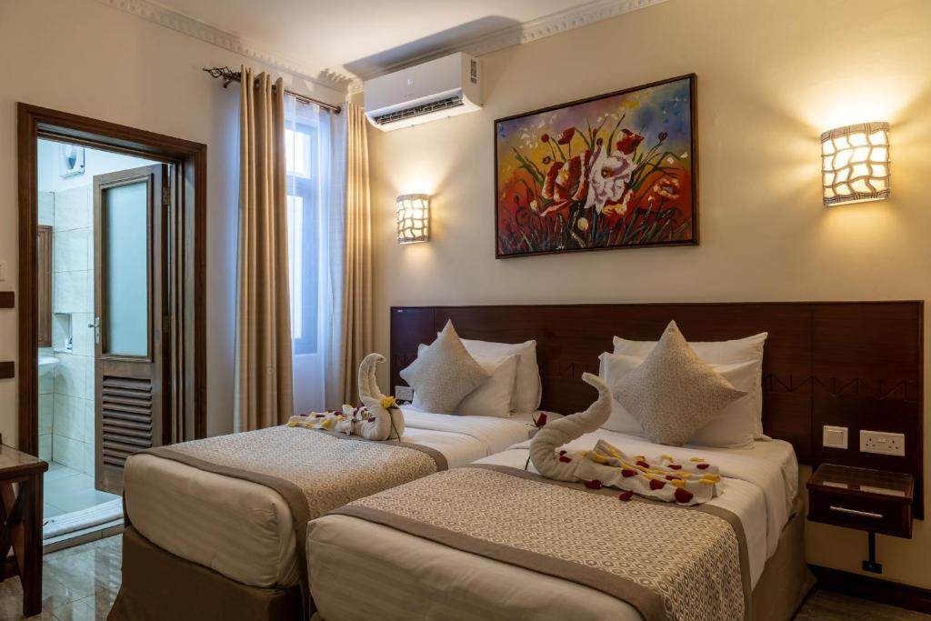 Postel nebo postele na pokoji v ubytování PrideInn Hotel Diani