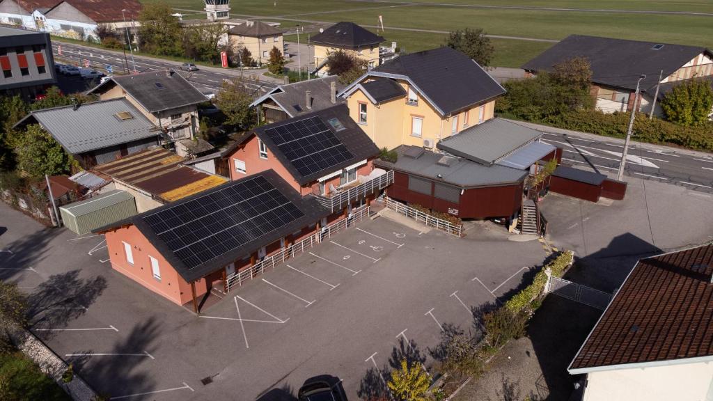 an overhead view of a house with solar panels on it at Contact hôtel Les Ailes in Challes-les-Eaux