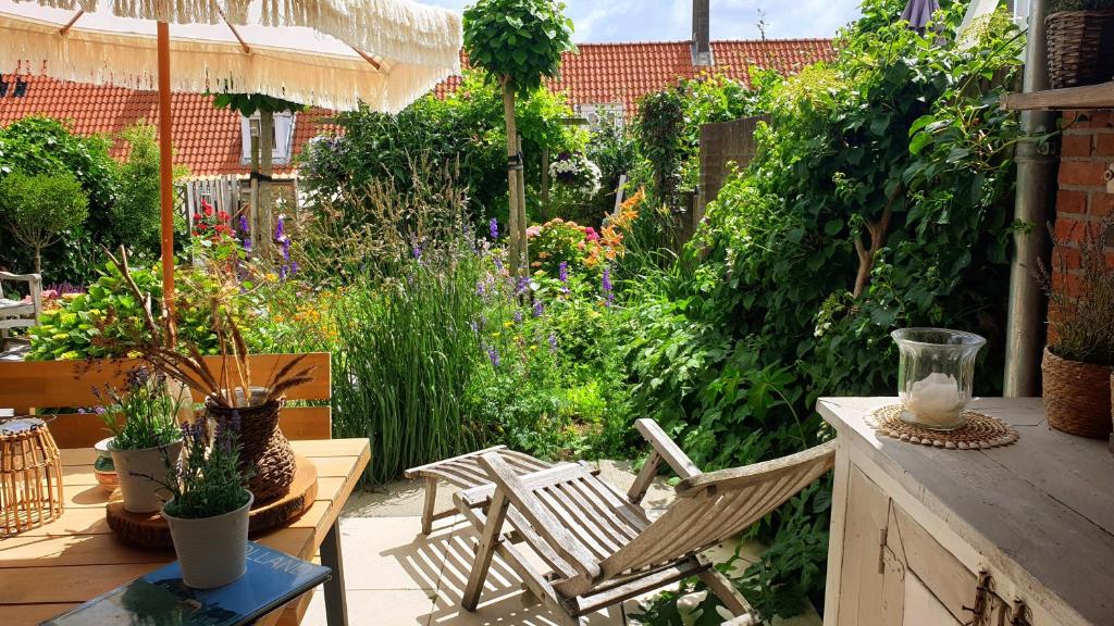 a patio with chairs and a garden with plants at Beachhouse Engelbert Studios in Zandvoort