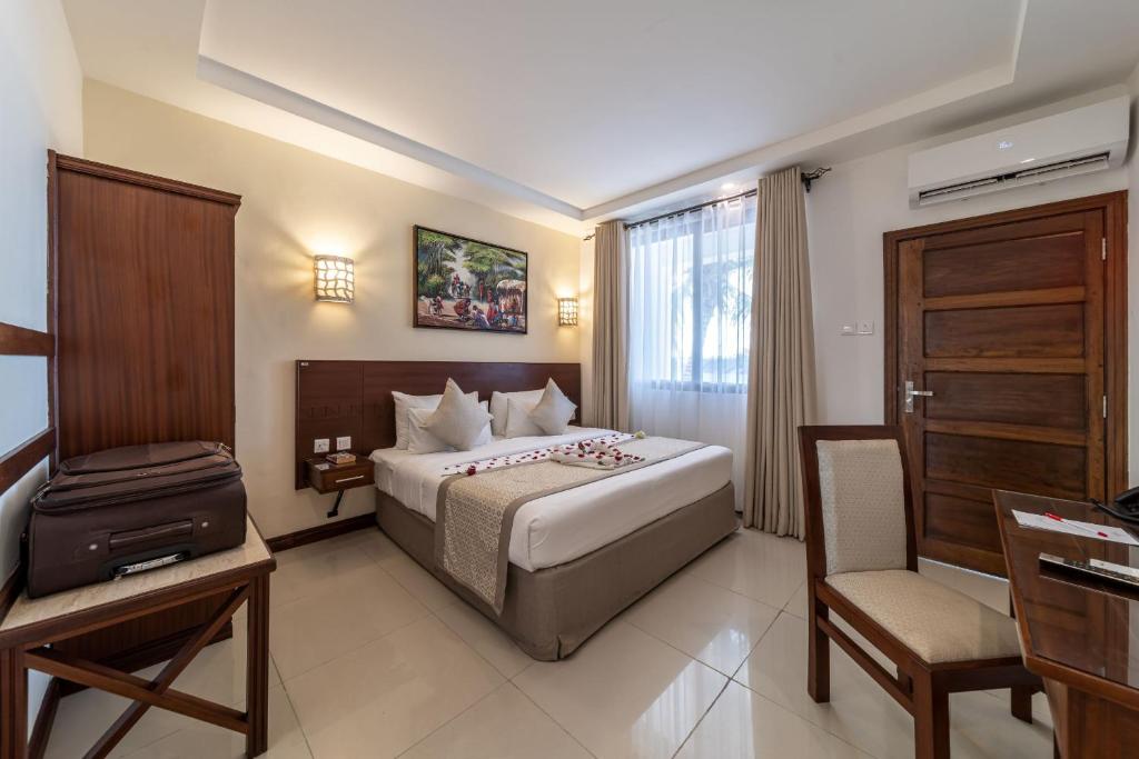 Postel nebo postele na pokoji v ubytování PrideInn Hotel Diani