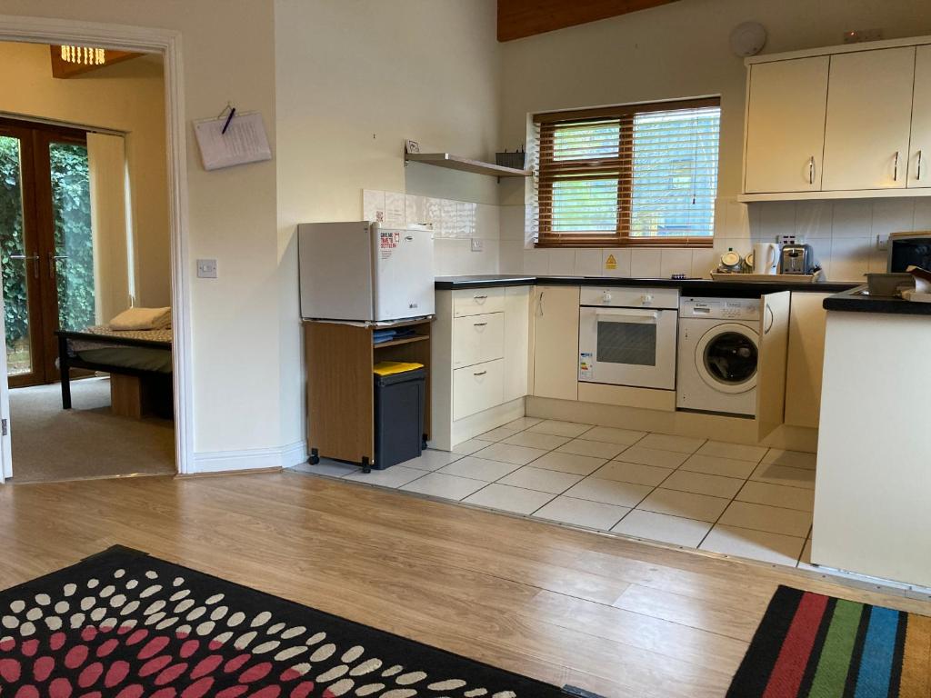 a kitchen with a refrigerator and a dishwasher at CV225AA Ground-Floor Flat Near Rugby School Self Check-in in Rugby