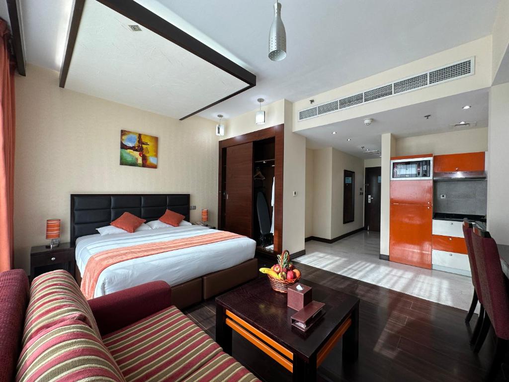 a hotel room with a bed and a couch at Marina View Deluxe Hotel Apartment in Dubai